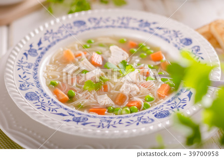 Spring chicken soup noodles, vegetable and toast Spring chicken soup noodles, vegetable and toast 39700958