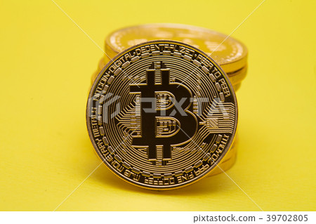 Stack of golden bitcoin on yellow brown concept sh Stack of golden bitcoin on yellow brown concept sh 39702805