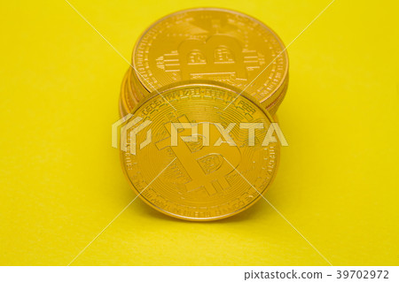 Stack of golden bitcoin on yellow brown concept Stack of golden bitcoin on yellow brown concept 39702972