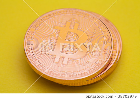 Stack of bronze color bitcoin on yellow background 39702979