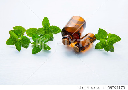 Natural Mint Essential Oil in a Glass Bottle. Natural Mint Essential Oil in a Glass Bottle. 39704173