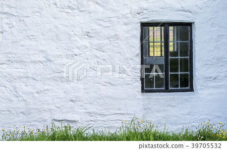 white, stone wall with a black window frame white, stone wall with a black window frame 39705532