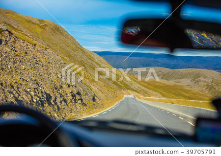 Driving a car by the mountain road Driving a car by the mountain road 39705791