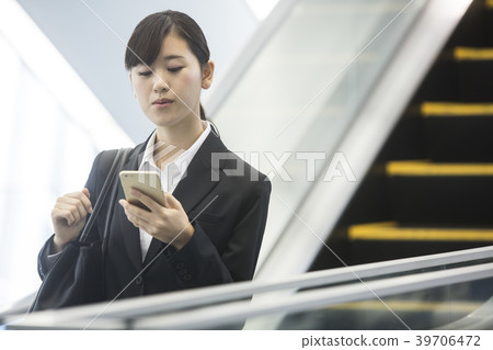 Business woman operating a smartphone Business woman operating a smartphone 39706472