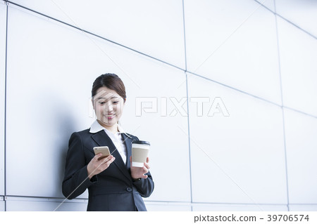 Business woman looking at smartphone during break Business woman looking at smartphone during break 39706574
