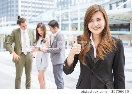 Business manager standing outdoor leading her team 39706629