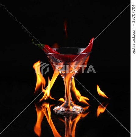 Hot chili pepper in a martini glass with a fire 39707704