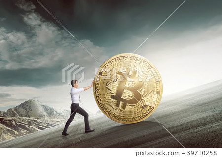 Young asian businessman pushing golden bitcoin 39710258