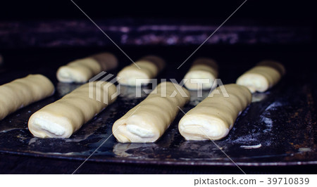 Sweet pastry going to the oven. Sweet pastry going to the oven. 39710839