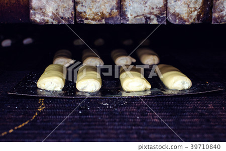 Sweet pastry going to the oven. Sweet pastry going to the oven. 39710840