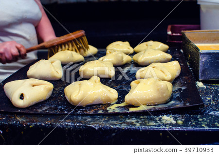 Sweet pastry going to the oven. Sweet pastry going to the oven. 39710933