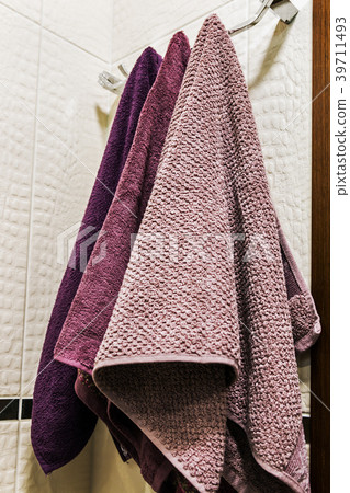 towels of different colors hanging on a hanger  towels of different colors hanging on a hanger  39711493