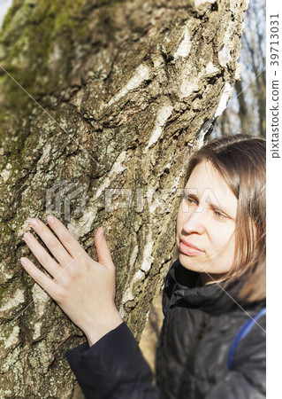 Girl hugging a huge tree trunk in the Park Girl hugging a huge tree trunk in the Park 39713031