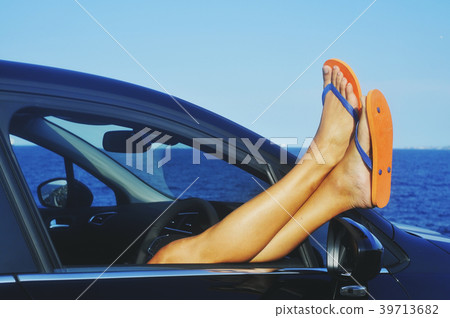 man relaxing in a car next to the ocean 39713682