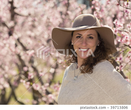 Inspiring beautiful woman in a grove of flowering fruit trees 39713806