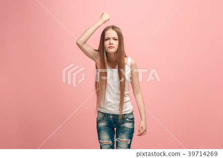 Portrait of angry teen girl on a pink studio Portrait of angry teen girl on a pink studio 39714269
