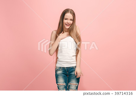 The happy teen girl standing and smiling against The happy teen girl standing and smiling against 39714316