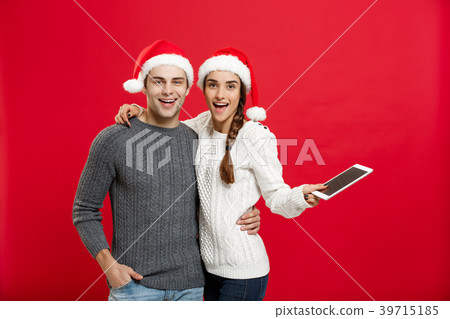 Christmas concept - Happy young couple in Christmas concept - Happy young couple in 39715185
