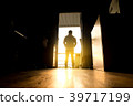 man silhouettes are standing outside at sunset 39717199