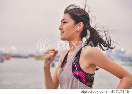 Sports concept. Beautiful girl is exercising on the beach with r Sports concept. Beautiful girl is exercising on the beach with r 39717846