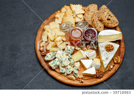 Brie cheese on a wooden Board with bread and sweet Brie cheese on a wooden Board with bread and sweet 39718983