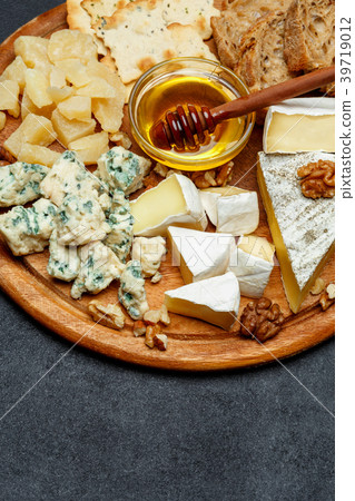 Brie cheese on a wooden Board with bread and sweet Brie cheese on a wooden Board with bread and sweet 39719012