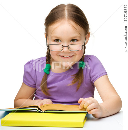 Cute cheerful little girl reading book 39719872