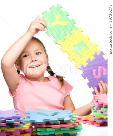 Cute little girl is holding Yes slogan 39720273