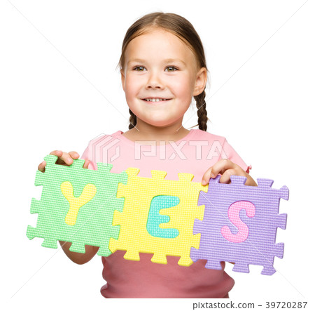 Cute little girl is holding Yes slogan 39720287