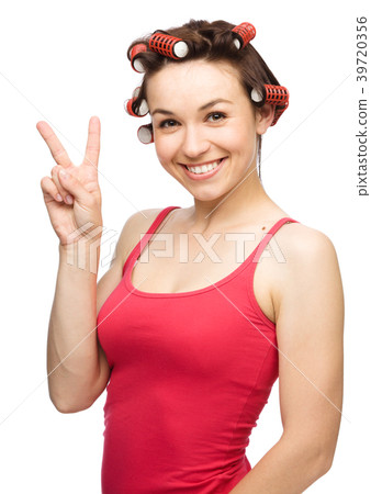 Woman is showing victory sign 39720356