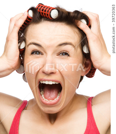 Woman is screaming holding her head with hands Woman is screaming holding her head with hands 39720363