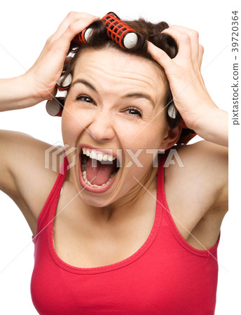 Woman is screaming holding her head with hands Woman is screaming holding her head with hands 39720364
