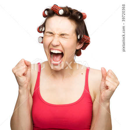 Woman is screaming holding her fists tight 39720368