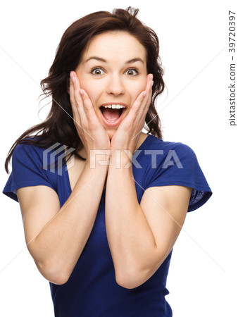 Woman is holding her face in astonishment 39720397