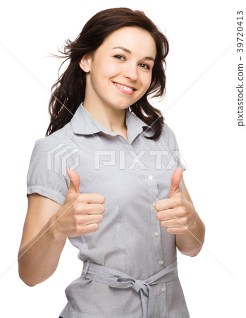Woman is showing thumb up gesture 39720413