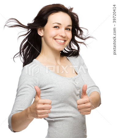 Woman is showing thumb up gesture Woman is showing thumb up gesture 39720414