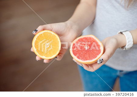 Orange and grapefruit in human's hands. Orange and grapefruit in human's hands. 39720416