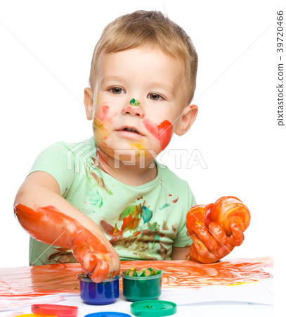 Child is grabbing some paint using fingers Child is grabbing some paint using fingers 39720466