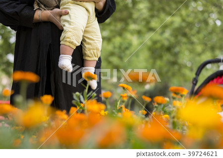 Young Muslim woman with her girl baby enjoying Young Muslim woman with her girl baby enjoying 39724621