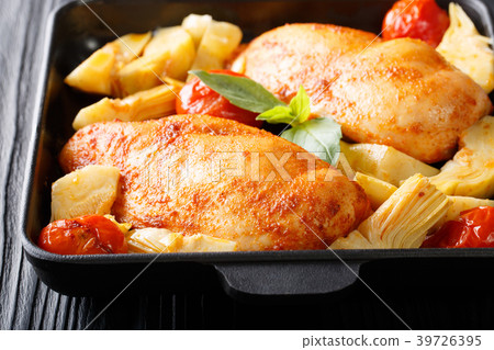 Baked chicken fillet with artichokes and tomatoes Baked chicken fillet with artichokes and tomatoes 39726395