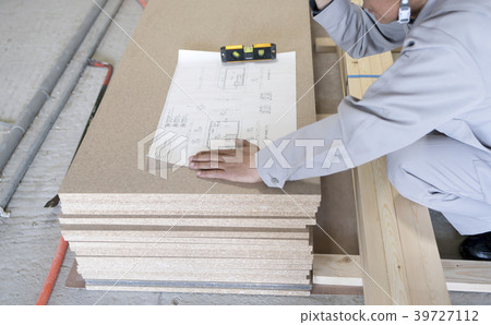 Workers checking apartment, skeleton renovation, construction site, and drawings Workers checking apartment, skeleton renovation, construction site, and drawings 39727112