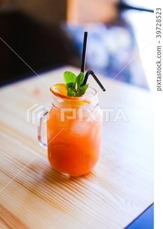 Glass of orange juice on wooden table in 39728523