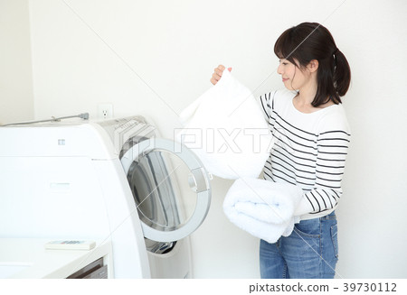 A woman holding laundry A woman holding laundry 39730112