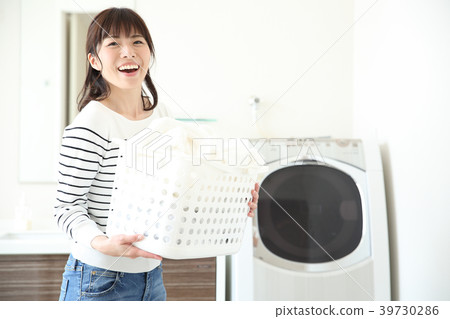 Woman doing the laundry Woman doing the laundry 39730286