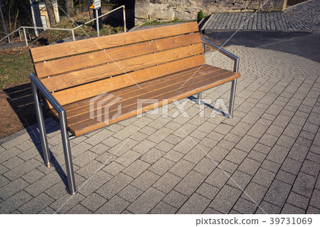 Wooden modern bench in the city with iron racks 39731069