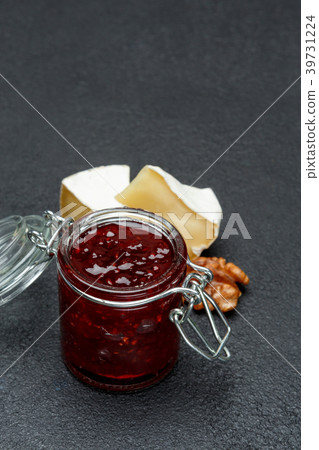 Jam of raspberries and pieces of brie cheese on 39731224