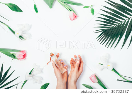 Cologne in female hands among the flowers 39732387