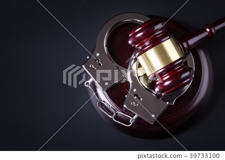 Wooden judge gavel and police handcuffs Wooden judge gavel and police handcuffs 39733100