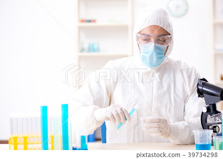 Young chemist student working in lab on chemicals 39734298