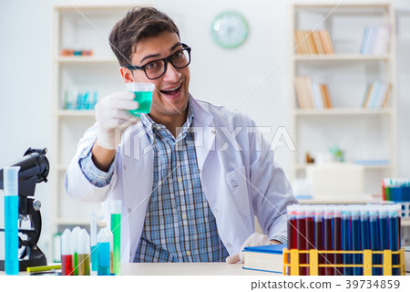 Young chemist student working in lab on chemicals 39734859
